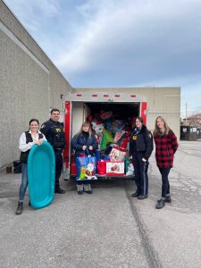 people with donations standing by truck